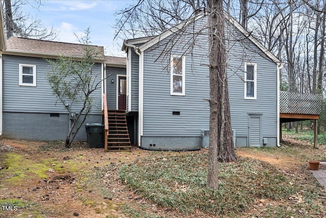 rear view of house with crawl space