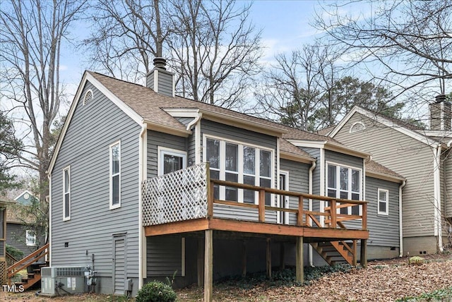 rear view of house featuring central air condition unit, a chimney, stairway, and roof with shingles