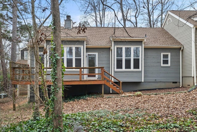 rear view of house featuring crawl space, a shingled roof, a chimney, and a wooden deck