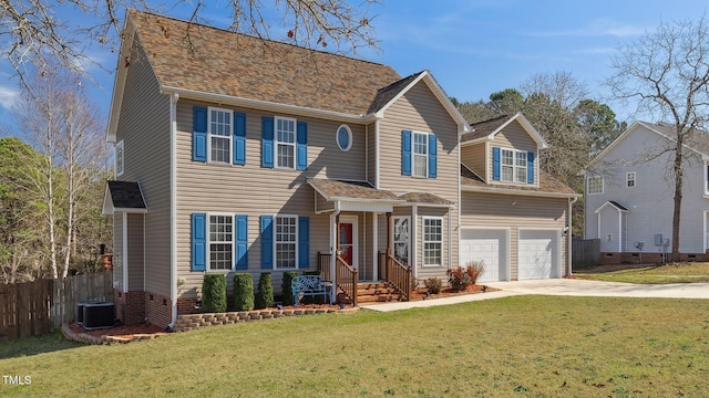 view of front of house with an attached garage, fence, concrete driveway, and a front yard