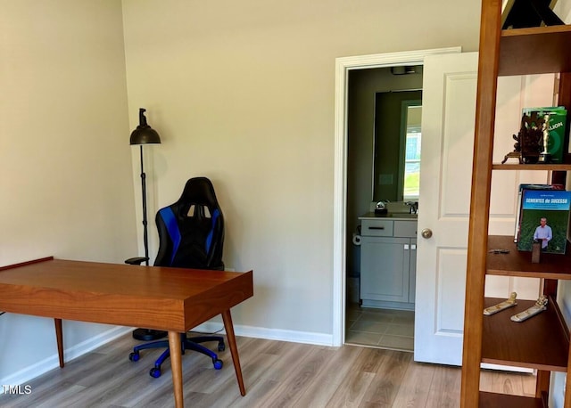 730 Firebrick Dr, Cary, NC 27519 - home office with light wood-style floors, baseboards, and a sink