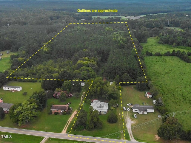 birds eye view of property featuring a forest view and a rural view