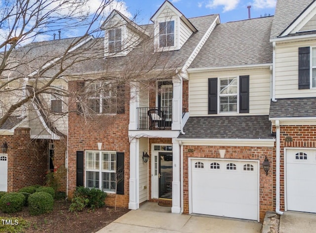 view of front of house with a garage, brick siding, concrete driveway, and roof with shingles