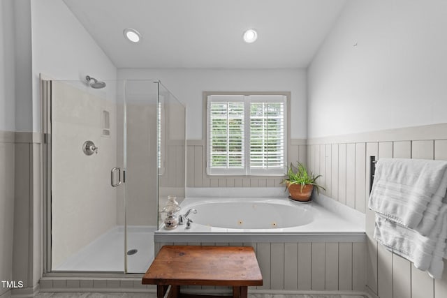 full bath with lofted ceiling, recessed lighting, a jetted tub, wainscoting, and a shower stall