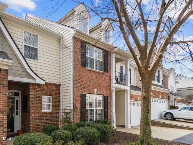 view of front of property featuring driveway, a garage, and brick siding