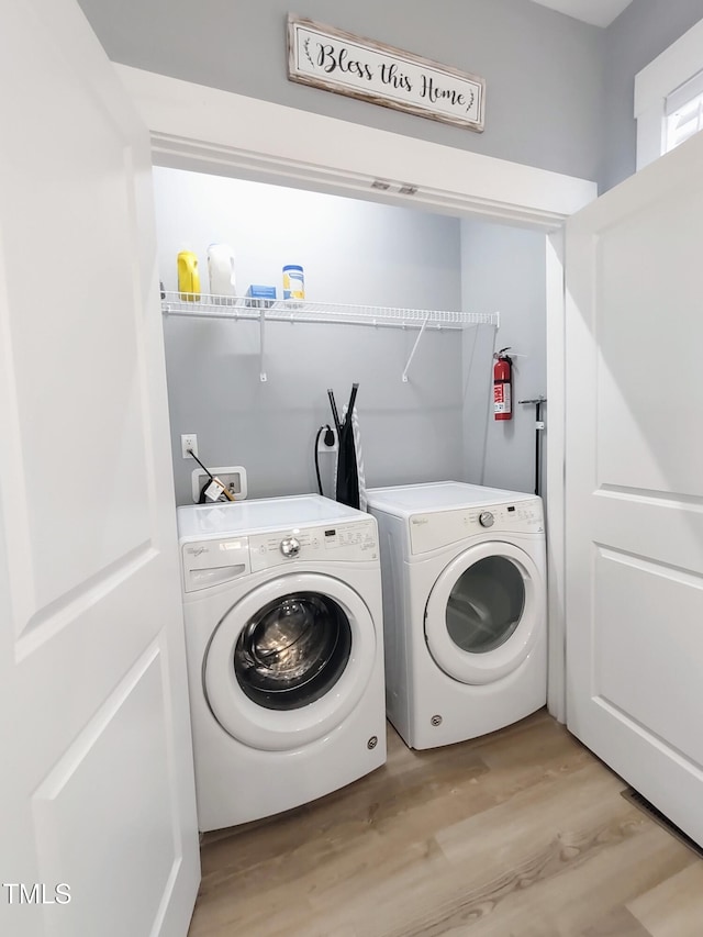 washroom with laundry area, light wood-style floors, and washer and dryer