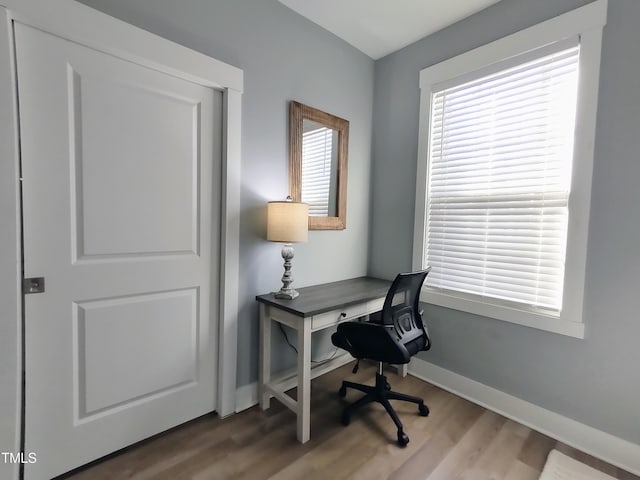 home office featuring wood finished floors and baseboards