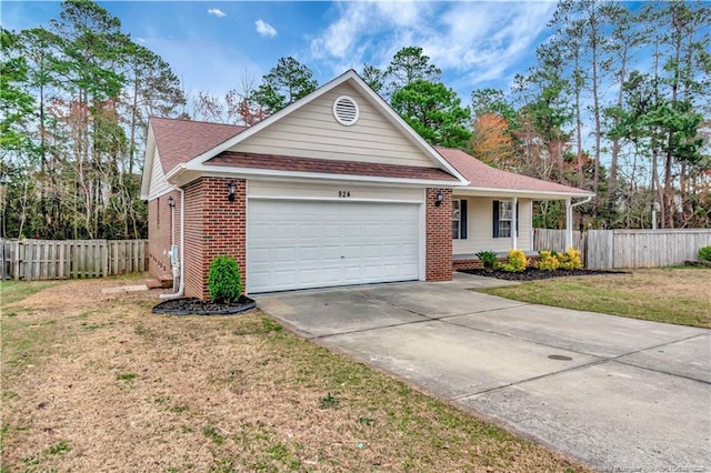 ranch-style home with brick siding, a front yard, a garage, and fence