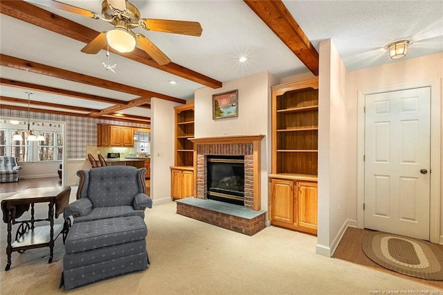 living area featuring a fireplace, baseboards, a wealth of natural light, and beamed ceiling