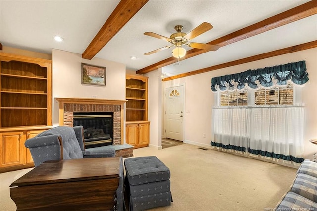 living room with visible vents, baseboards, light colored carpet, a brick fireplace, and beam ceiling