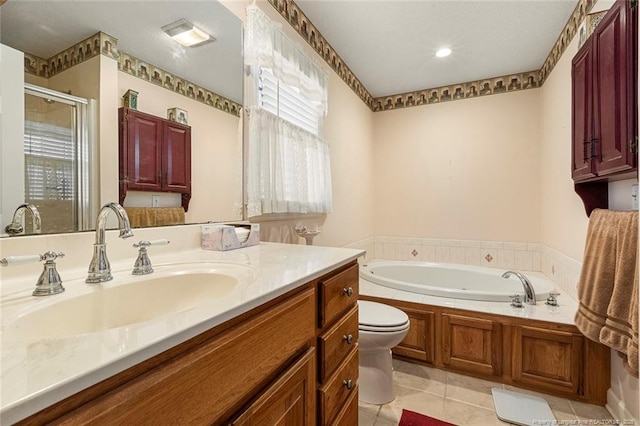 bathroom featuring a stall shower, toilet, a garden tub, tile patterned flooring, and vanity