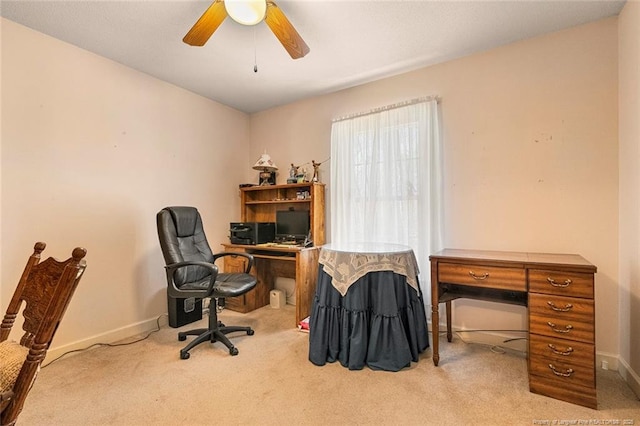 office area with a ceiling fan, carpet, and baseboards