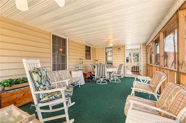 sunroom / solarium featuring ceiling fan