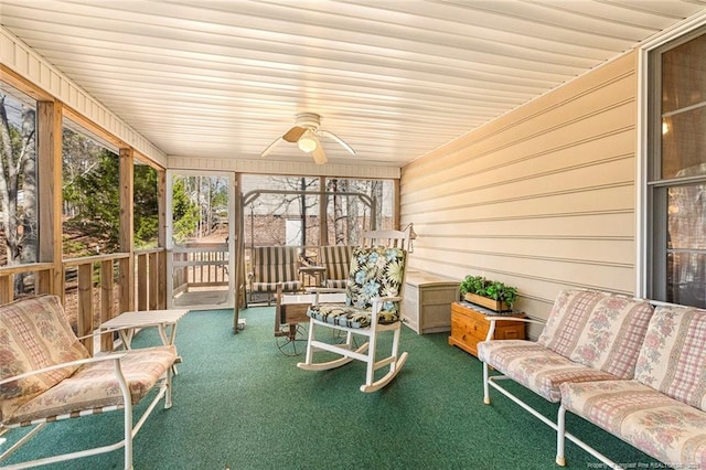 sunroom featuring ceiling fan