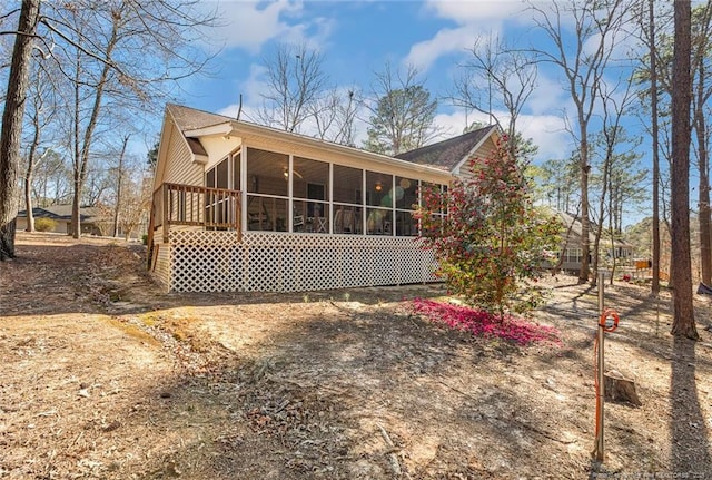 rear view of property featuring a sunroom