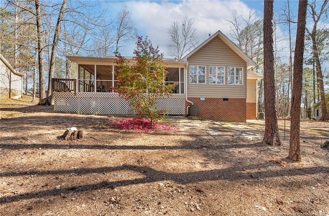 back of property featuring crawl space and a sunroom