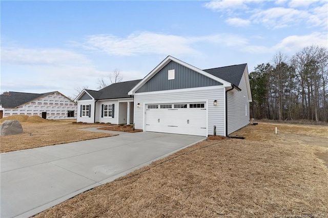 view of front of property with board and batten siding, concrete driveway, and a garage