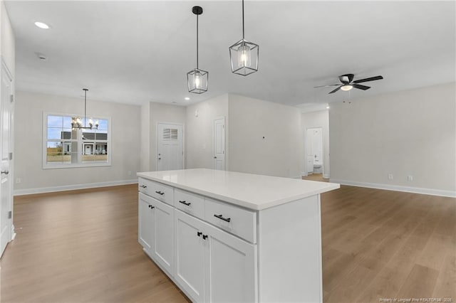 kitchen with light wood-style floors, open floor plan, light countertops, and white cabinets