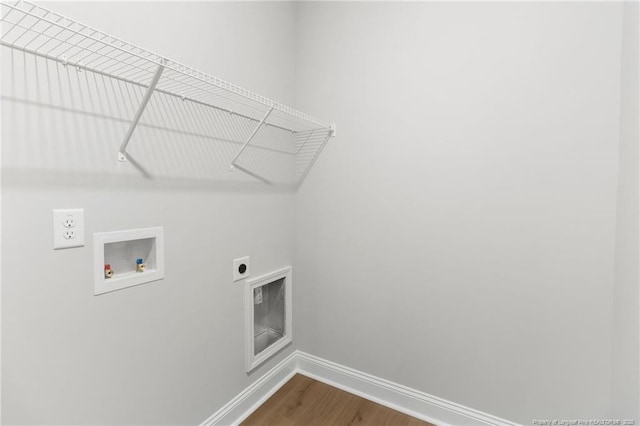 washroom featuring washer hookup, dark wood finished floors, hookup for an electric dryer, laundry area, and baseboards