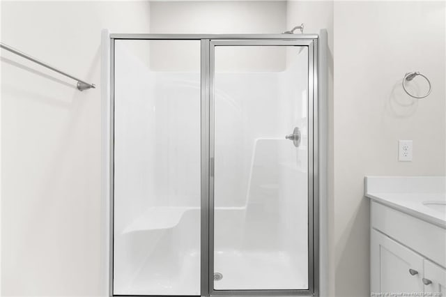 bathroom featuring a stall shower and vanity