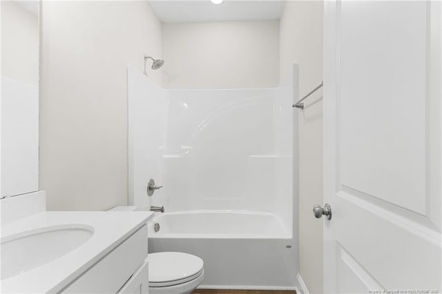 full bathroom with tub / shower combination, vanity, and toilet