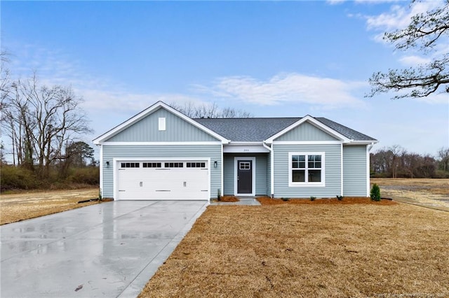 ranch-style house featuring a garage, concrete driveway, a shingled roof, and a front lawn