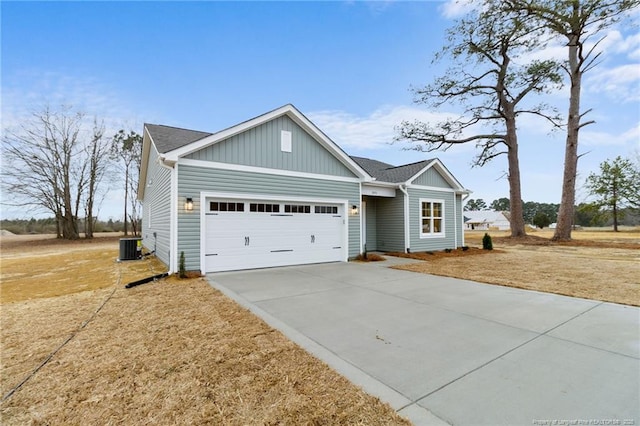 ranch-style home with driveway, a garage, and central AC unit