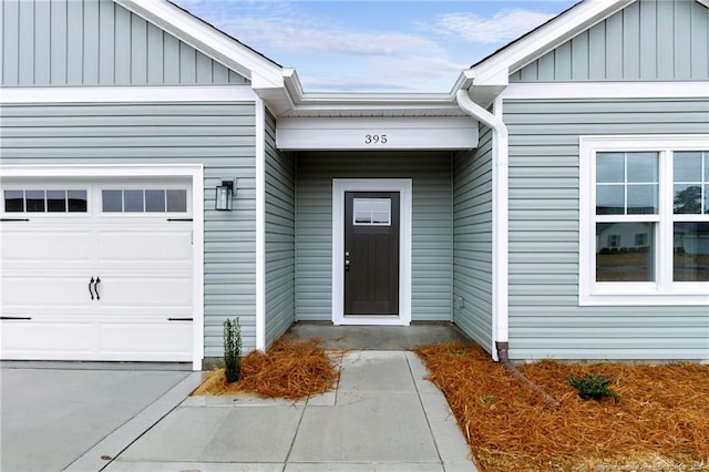 entrance to property featuring a garage and board and batten siding