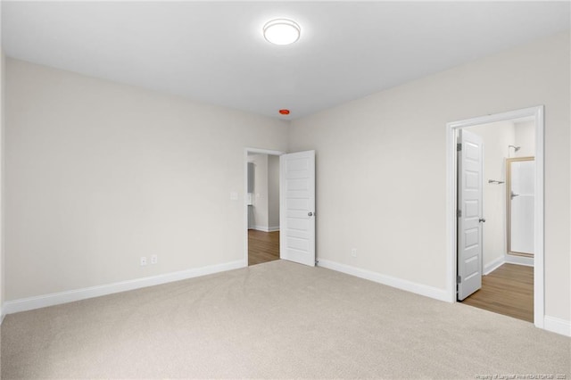 unfurnished bedroom featuring carpet flooring and baseboards