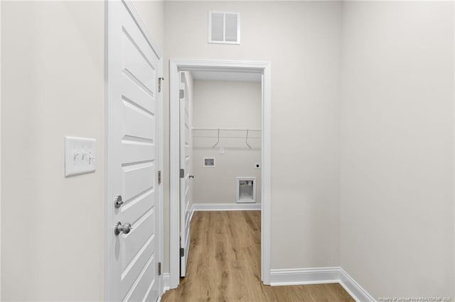 washroom with hookup for a washing machine, visible vents, light wood-style flooring, laundry area, and baseboards