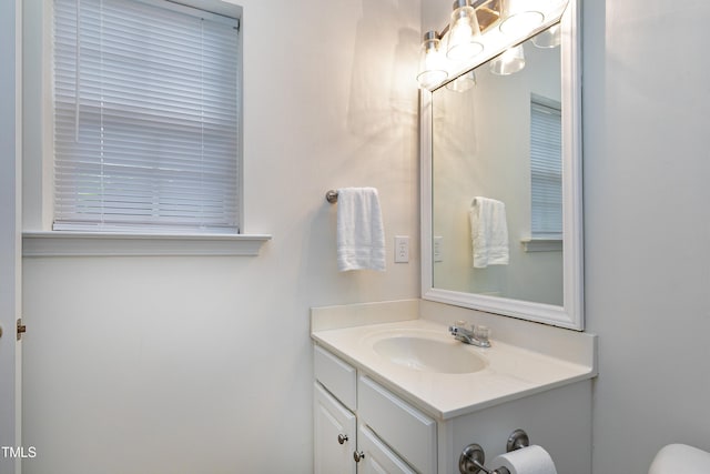 half bathroom featuring toilet and vanity