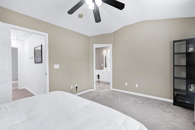 bedroom with attic access, lofted ceiling, carpet flooring, and baseboards