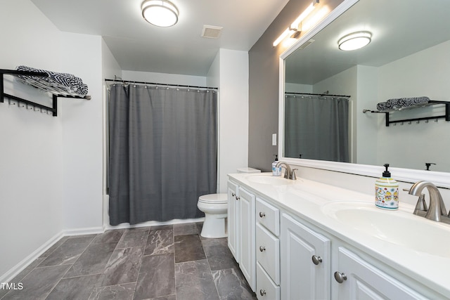 bathroom with visible vents, a sink, toilet, and double vanity