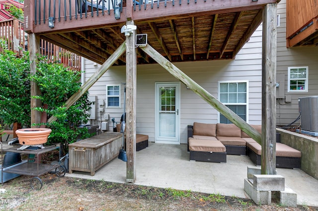 view of patio / terrace with central AC unit and an outdoor living space