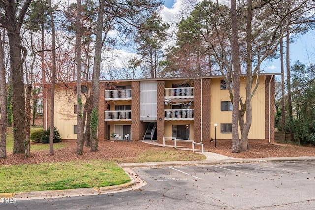 view of building exterior featuring uncovered parking