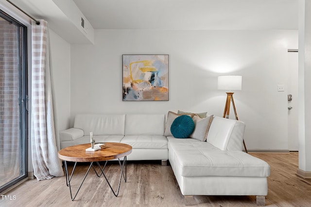 living room with baseboards and wood finished floors