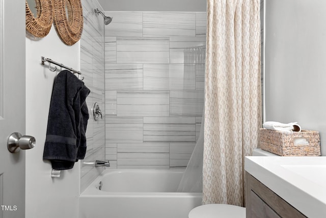 bathroom featuring vanity, shower / tub combo, and toilet