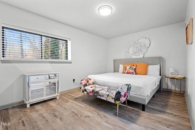 bedroom featuring baseboards and wood finished floors