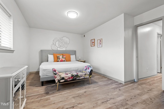 bedroom featuring light wood-type flooring and baseboards