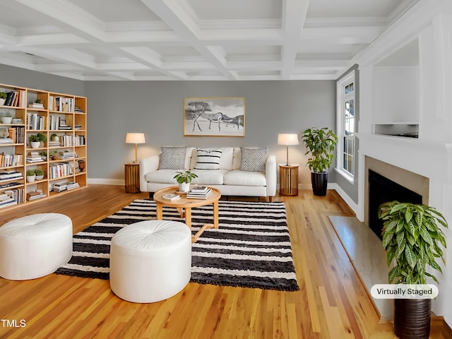 living room with a fireplace with flush hearth, beam ceiling, coffered ceiling, and wood finished floors