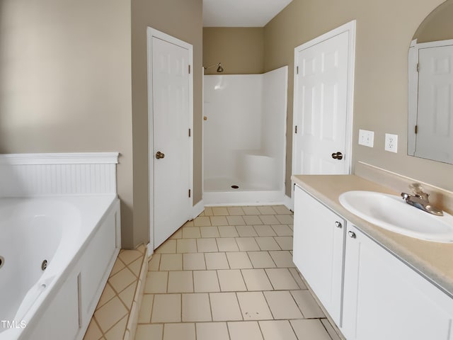 bathroom with a tub with jets, walk in shower, and vanity