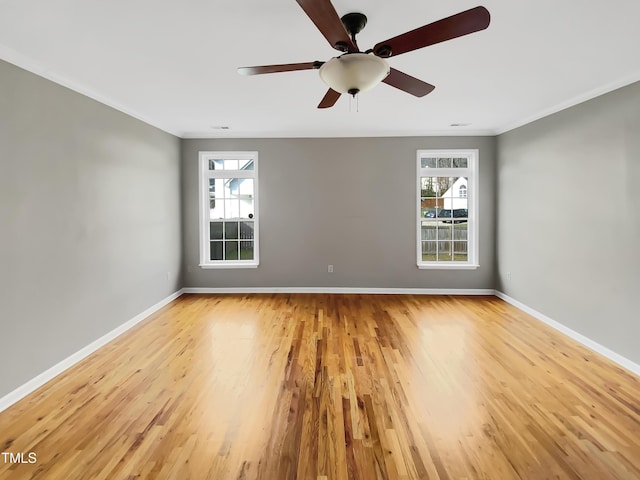 unfurnished room featuring light wood-style flooring, baseboards, and ornamental molding