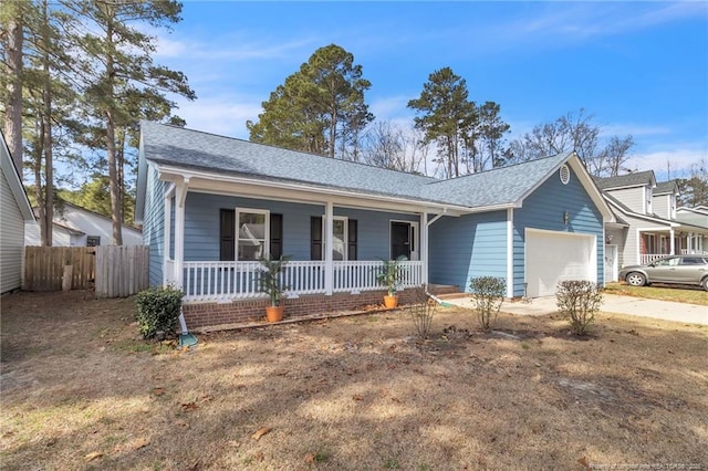 ranch-style home featuring an attached garage, covered porch, fence, driveway, and roof with shingles