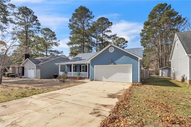 ranch-style house with driveway, an attached garage, fence, a front lawn, and a porch