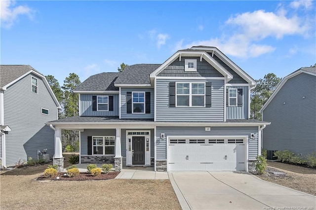 craftsman inspired home featuring a porch, concrete driveway, stone siding, and board and batten siding