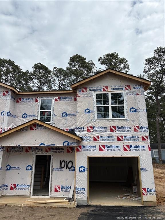 unfinished property with a garage