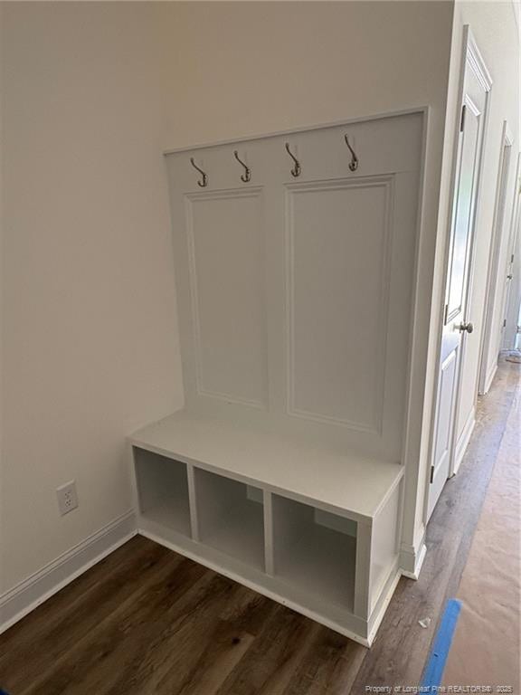 mudroom with wood finished floors and baseboards
