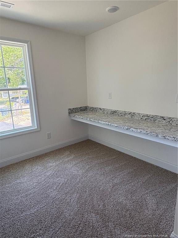 spare room with carpet floors and baseboards