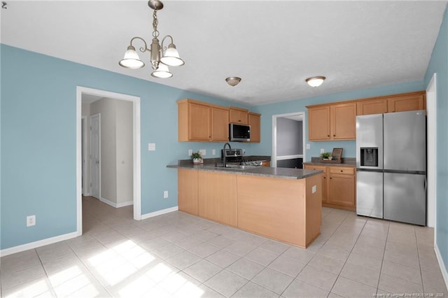 kitchen featuring light tile patterned floors, stainless steel appliances, dark countertops, a peninsula, and baseboards