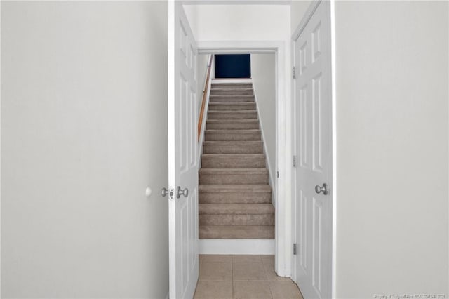 stairway with tile patterned floors